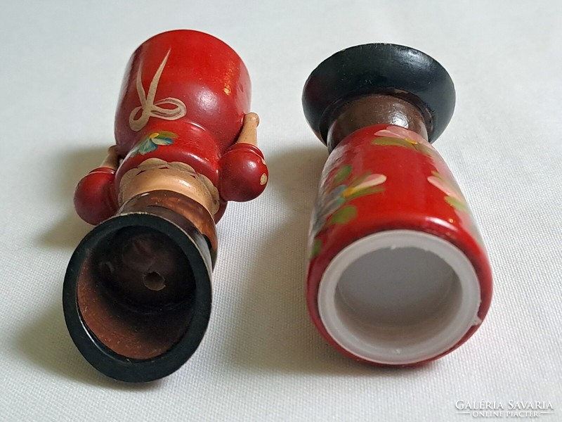 A pair of wooden salt and pepper shaker figurines, hand-painted with a Kalocsa pattern
