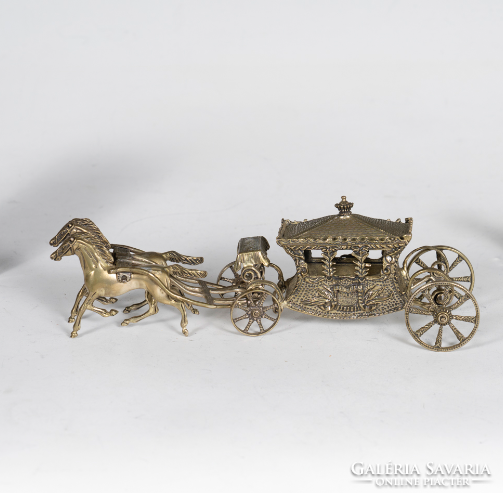 Silver horse-drawn carriage with teeth