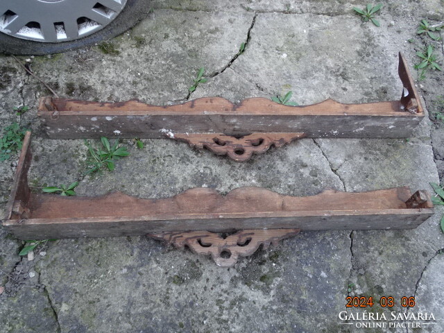 A pair of antique folk peasant carved wooden cornice curtain holders