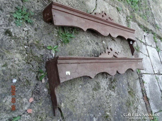 A pair of antique folk peasant carved wooden cornice curtain holders