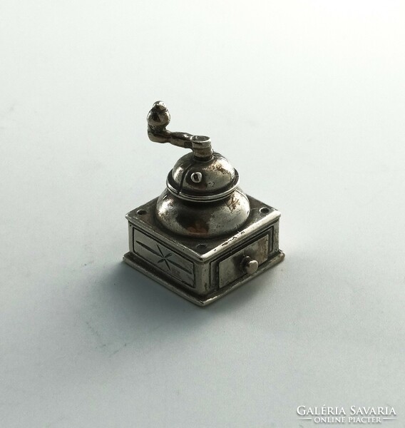 Silver ornament, grinder