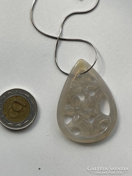 Special floral teardrop stone pendant on a silver snake chain.