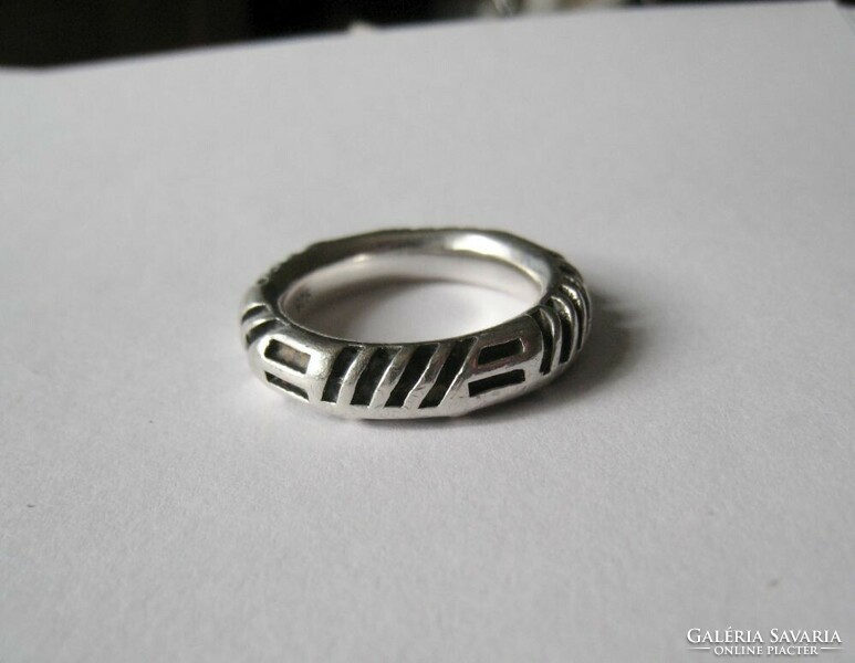 Solid silver ring with linear decorations
