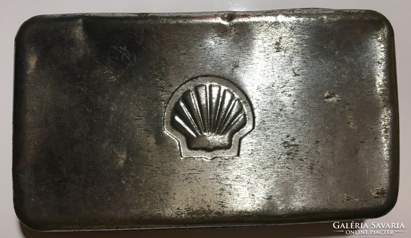Embossed metal logo printed in the vintage material of a Shell metal box