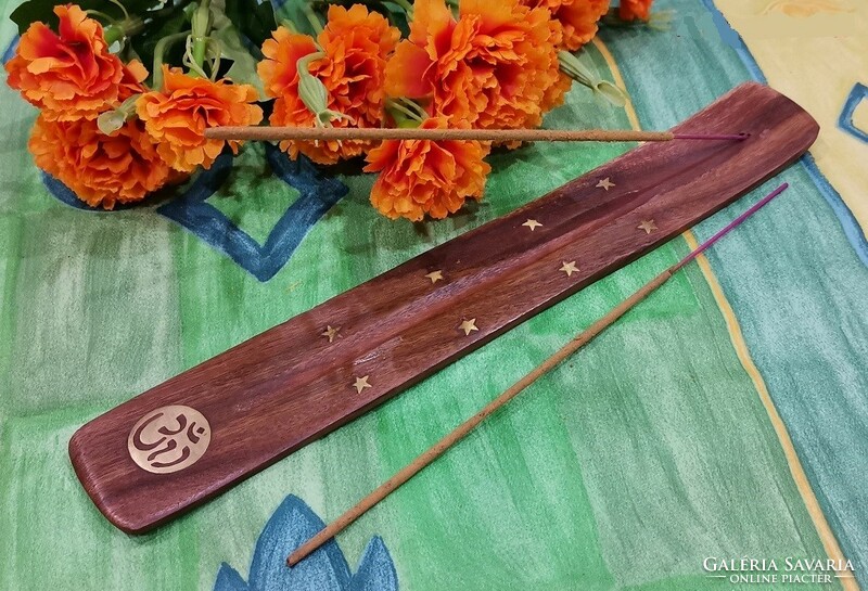 Wooden incense base decorated with a copper ohm sign and stars