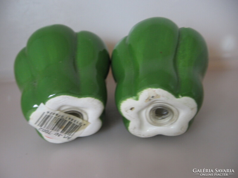 A pair of salt, pepper shakers and table spice holders in the form of green peppers