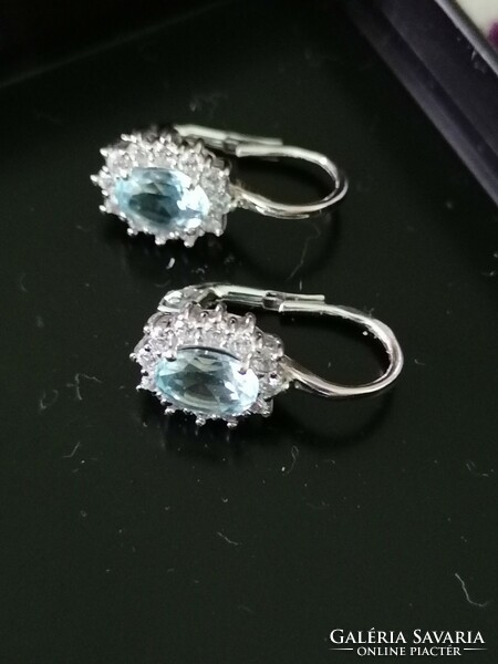 Gold earrings with blue topaz gemstones