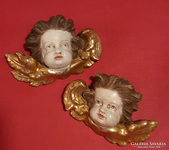 Old carved wooden putto heads