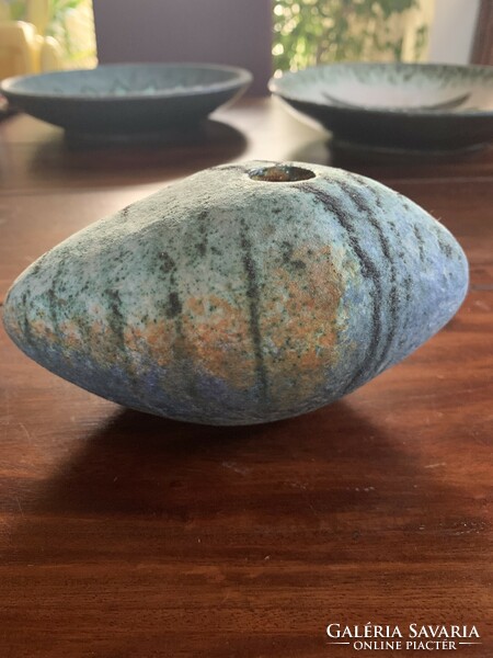 Smooth pebble vase on the bed
