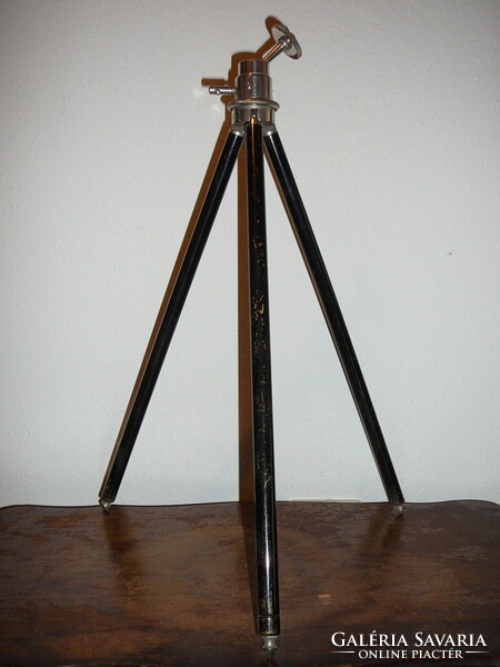 An old camera tripod with extendable legs, adjustable with a rarer ball joint.