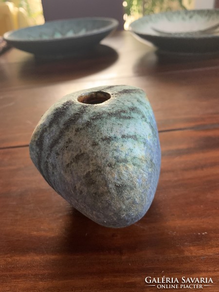Smooth pebble vase on the bed