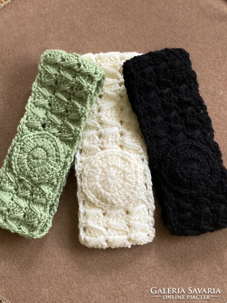 Three crocheted headbands in green, butter and black