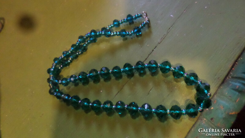 50 cm necklace made of dark green faceted crystal beads.