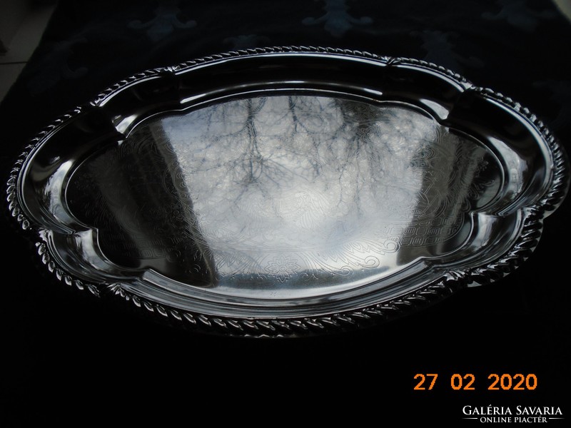 Chrome-nickel metal tray with a baroque shape, embossed rim, and chiseled antique patterns