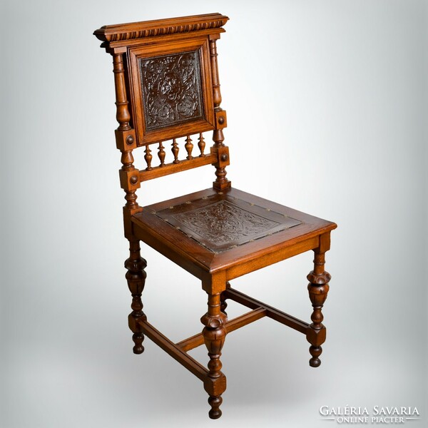 Refurbished antique chair with leather inserts