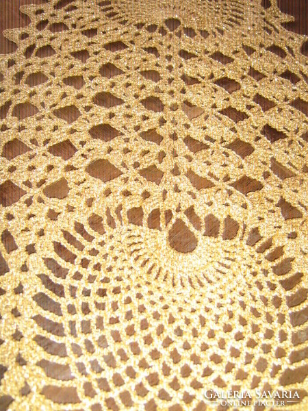 Beautiful hand-crocheted shiny golden tablecloth