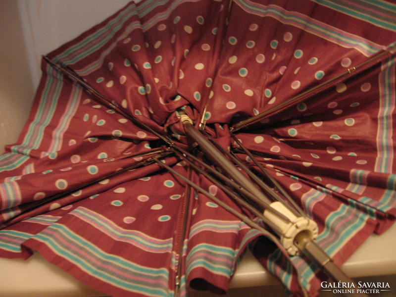 Retro polka dot-striped umbrella for repair