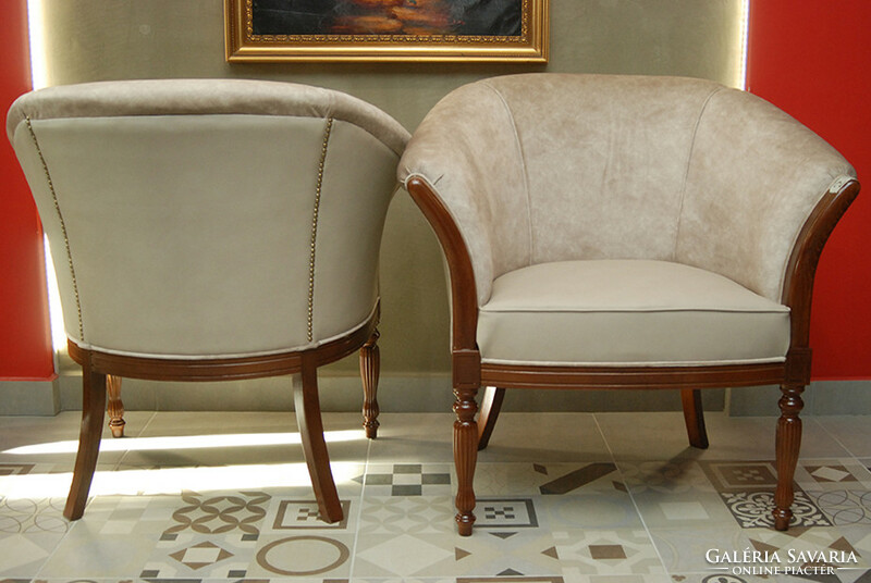 A pair of armchairs with art deco characters