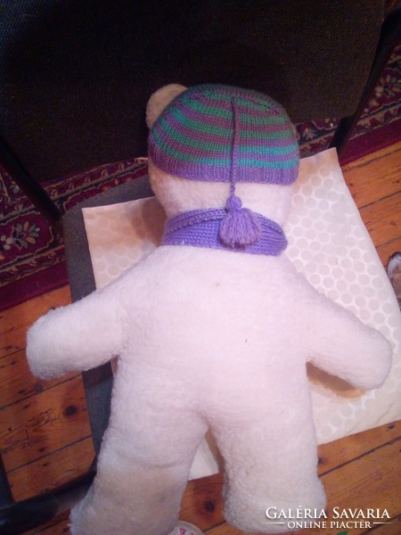 Craft teddy bear in purple scarf and hat