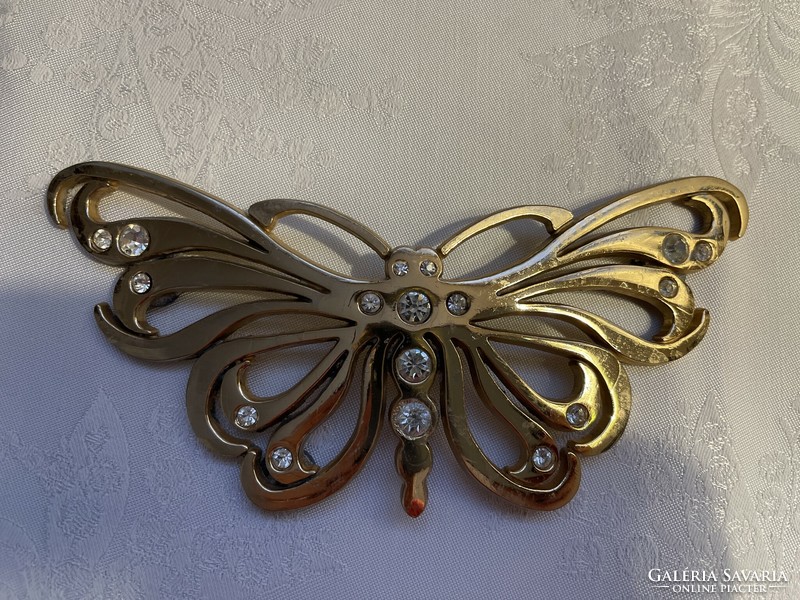 Large metal butterfly decorated with stones.