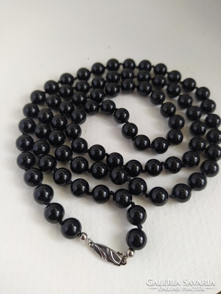 Long onyx necklace knotted with a silver clasp