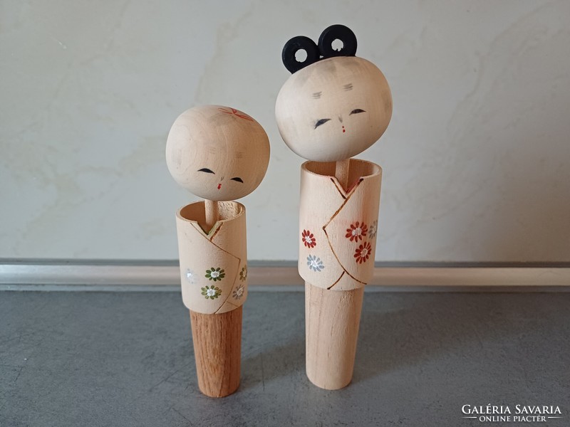 A pair of collectible kokeshi wooden dolls