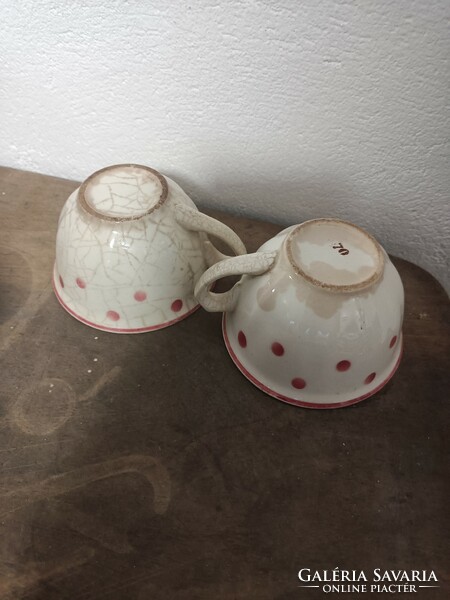 Two hardware cups with red dots.