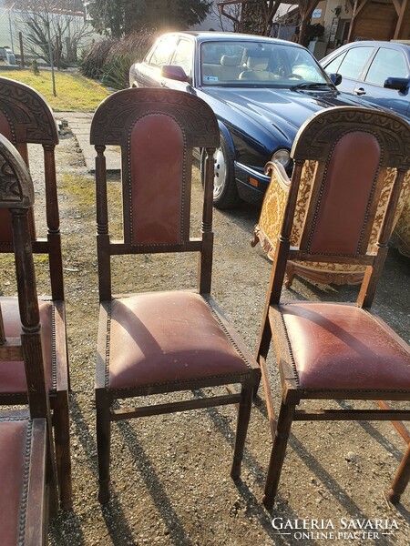 Antique, riveted, carved leather chairs.