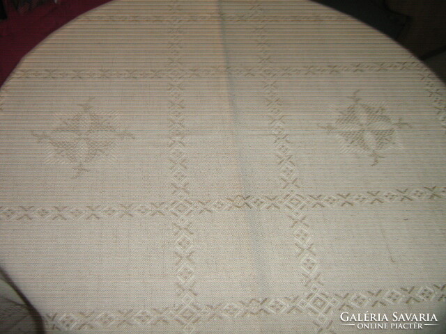 Beautiful elegant beige woven tablecloth with fringed edges
