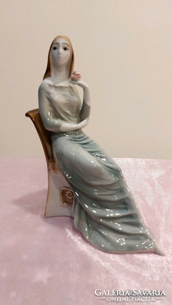 Zsolnay porcelain, Nora sitting on a chair.