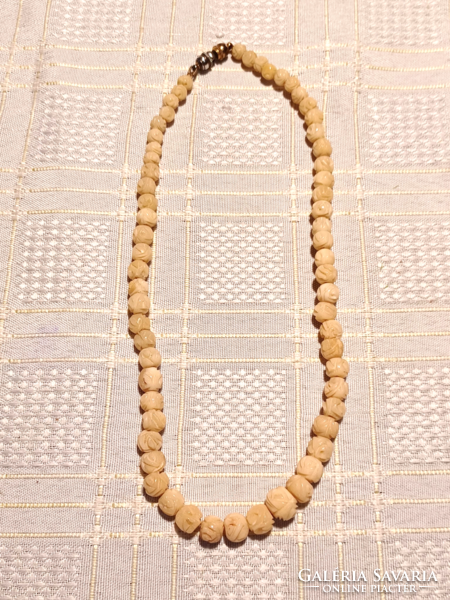Carved bone necklace with magnetic closure