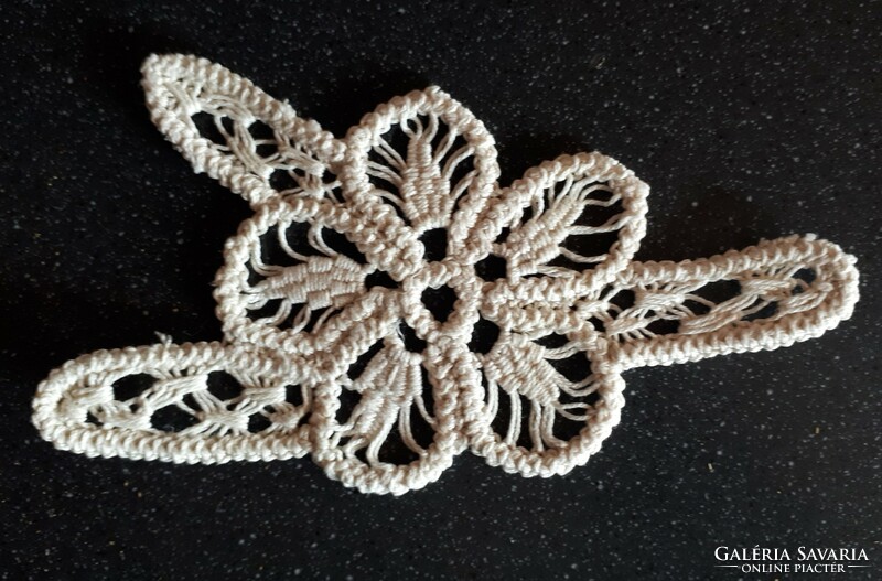An appliqué garment ornament made with cord crochet