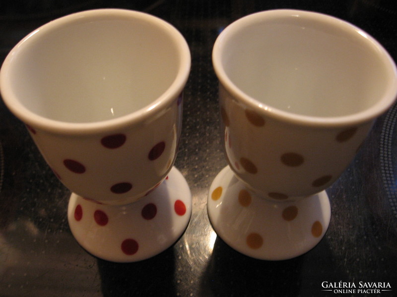 A pair of polka dot egg holders in burgundy and gold
