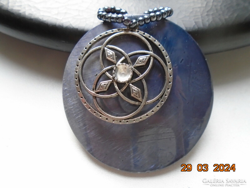 Shell and silver-plated Celtic pendant strung together, with a small metallic blue pearl hook