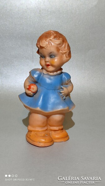 Old rubber figure of a little girl with an apple from the 50s