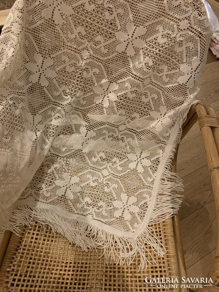 A very beautiful lace tablecloth with a fringe border