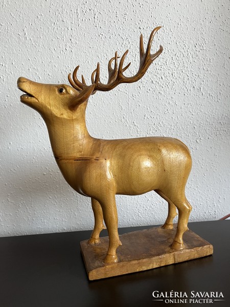Old, meticulously crafted wood carved deer