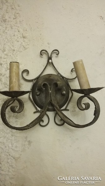 Wrought iron wall arms look very good in a wine cellar