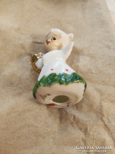 A tiny porcelain candle holder girl