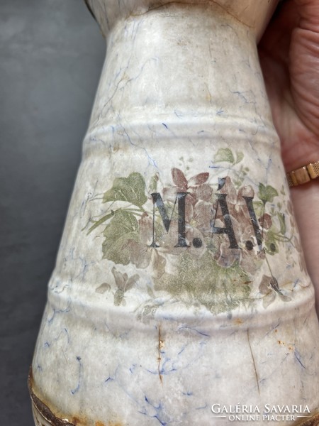Old and weathered mauve enamel jug