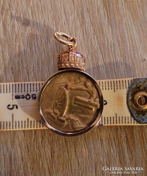 A really rare gold-framed crown coin pendant.