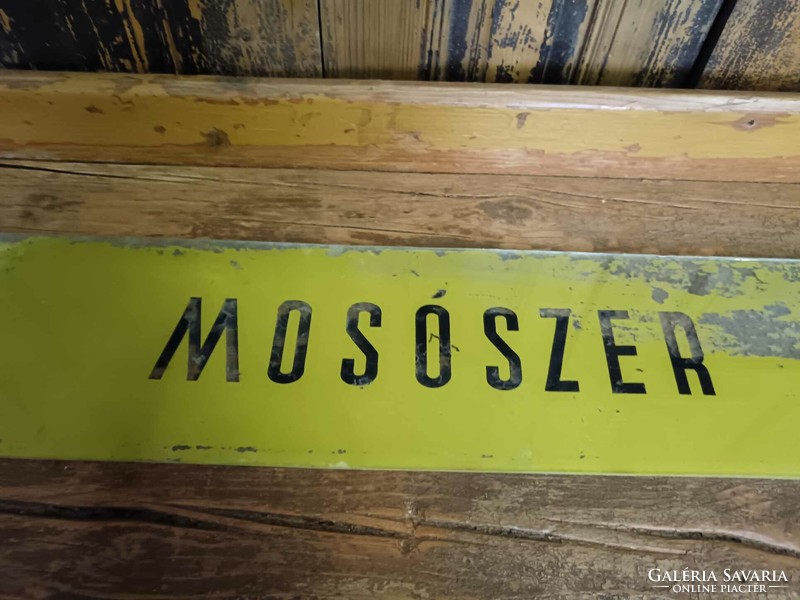 Old glass sign with painted detergent label, mid-20th century household store, colander store,