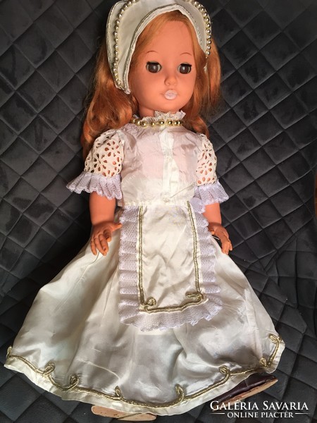 Little girl in old, retro Hungarian, palatial dress with doll party, in boots