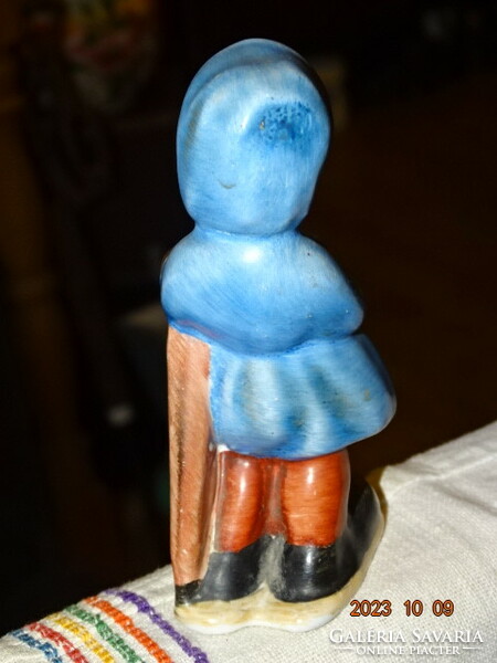 Old brightly colored painted ceramic girl with umbrella