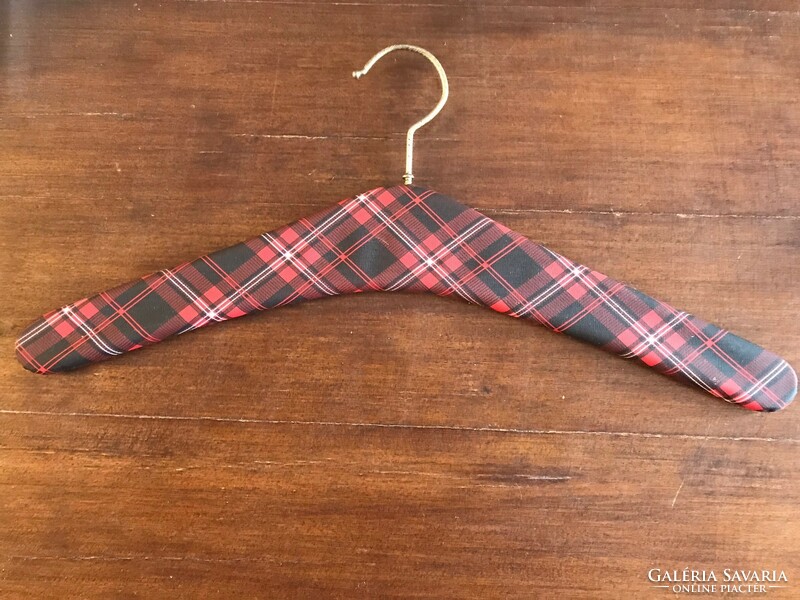 Retro clothes hanger. Shoulder wood. With red checkered leather.