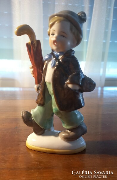 Porcelain figurine of a boy with an umbrella