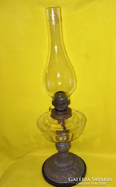 Old table kerosene lamp, metal base, glass container.