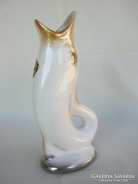 Craftsman in retro ceramic fish shaped vase