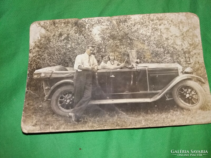 Antique sepia postcard of the proud owner and his family with perhaps a rover (?) car according to the pictures
