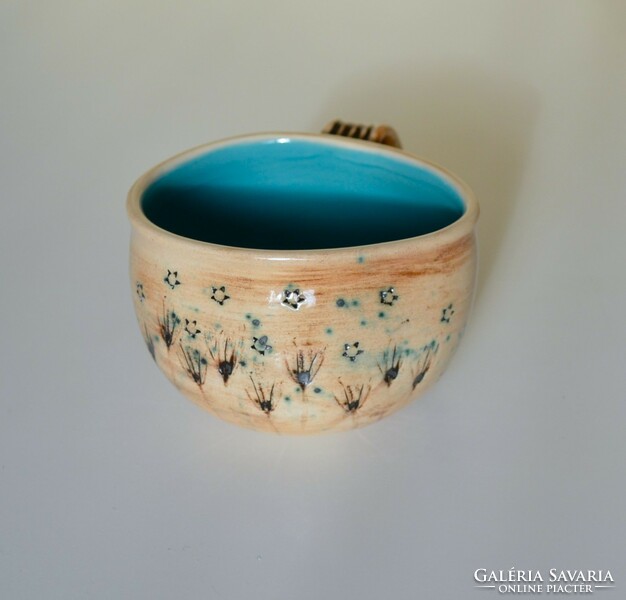 Curved ceramic tea mug with plant print